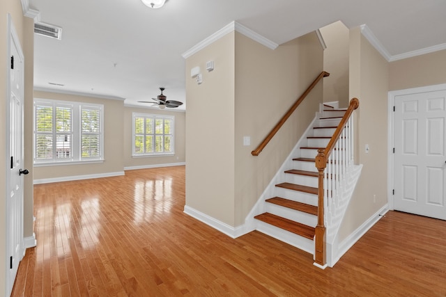 3588 Bagley Dr, Mount Pleasant, SC 29466 - staircase featuring ornamental molding, a ceiling fan, wood finished floors, and baseboards