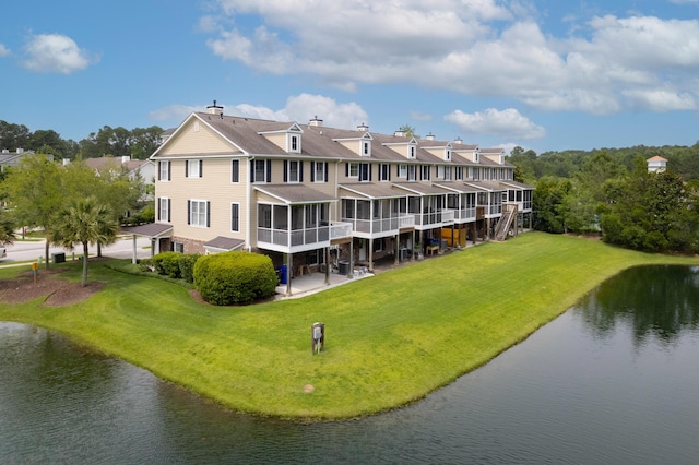 3588 Bagley Dr, Mount Pleasant, SC 29466 - rear view of property featuring a sunroom, a water view, a lawn, and a chimney