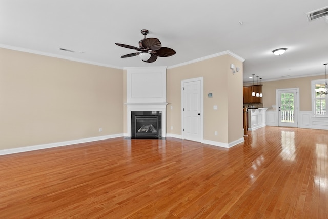 3588 Bagley Dr, Mount Pleasant, SC 29466 - unfurnished living room featuring ceiling fan, light wood-style floors, a fireplace with flush hearth, ornamental molding, and baseboards