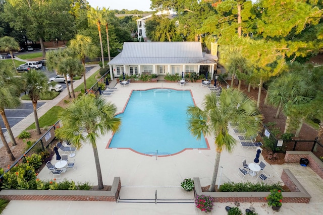 community pool featuring a patio area and fence