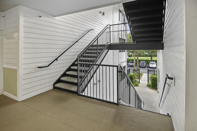 staircase with concrete floors