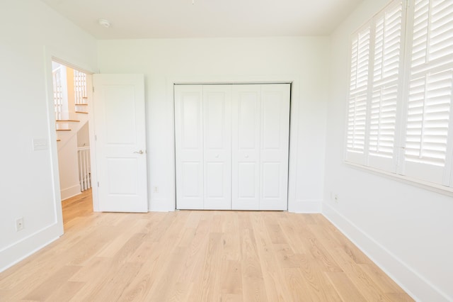 173 Coming St Unit B, Charleston, SC 29403 - unfurnished bedroom featuring light wood-style floors and a closet