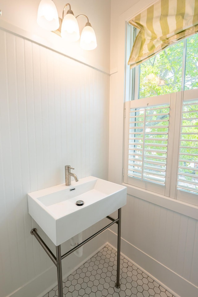 173 Coming St Unit B, Charleston, SC 29403 - bathroom featuring a decorative wall, wainscoting, and tile patterned flooring