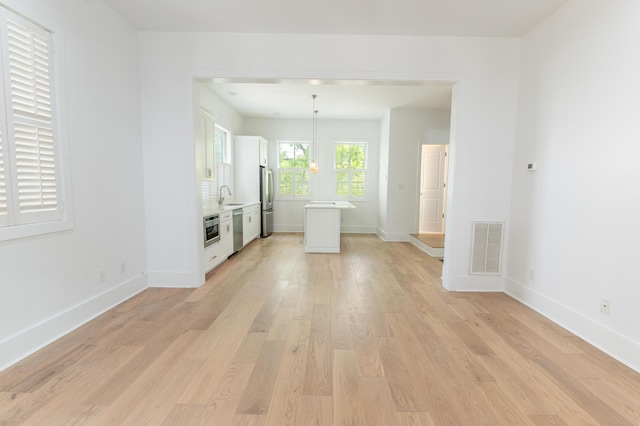 173 Coming St Unit B, Charleston, SC 29403 - unfurnished living room featuring a sink and light wood-style floors
