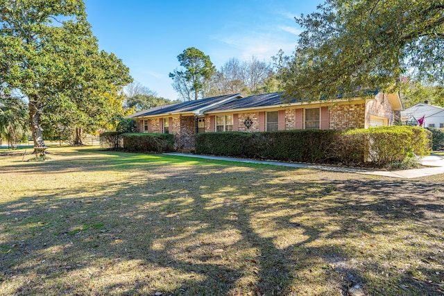 ranch-style house with brick siding and a front lawn