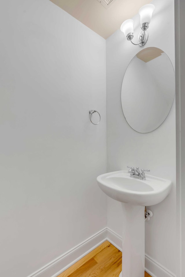 bathroom featuring baseboards and wood finished floors