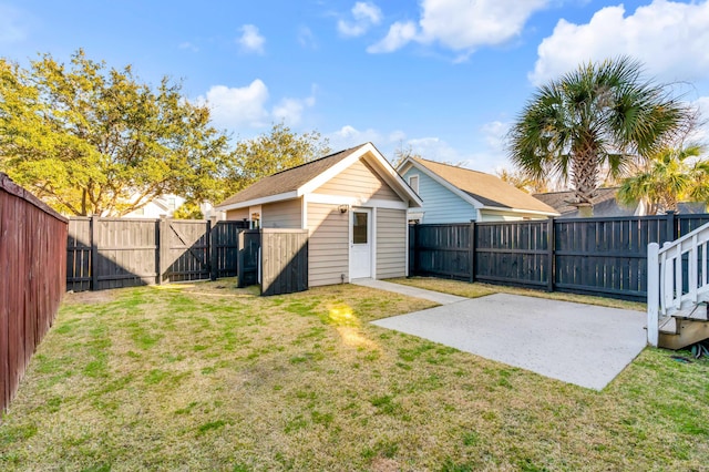 back of property featuring a shed, a lawn, an outdoor structure, a fenced backyard, and a patio