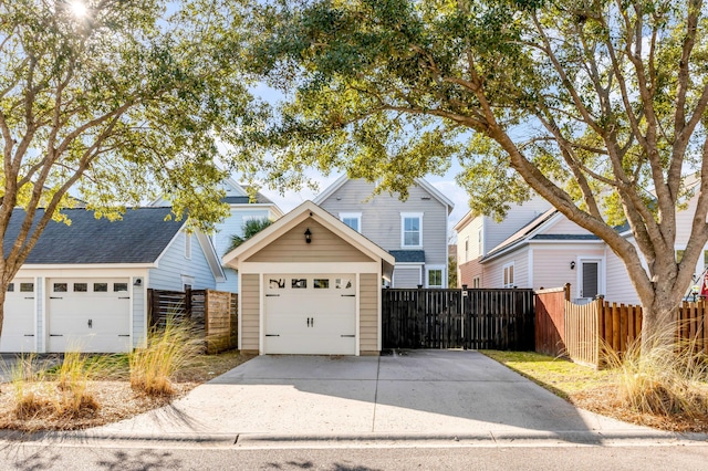 traditional-style house with a garage, an outdoor structure, and fence