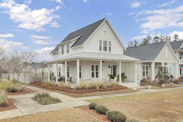 view of front of house featuring covered porch and a front yard