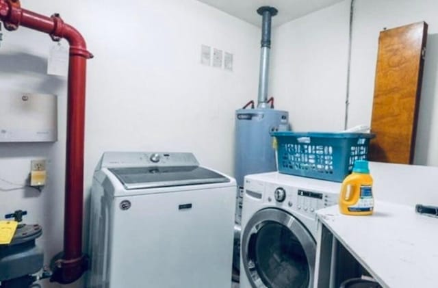 laundry area featuring gas water heater and independent washer and dryer