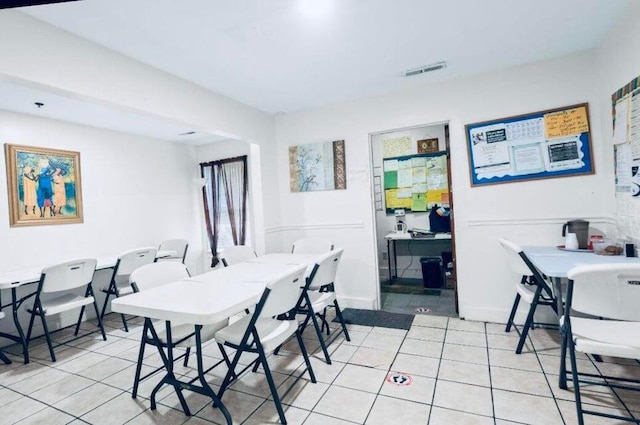 dining area with light tile patterned flooring