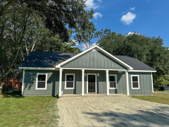 view of front of house with a porch and a front yard