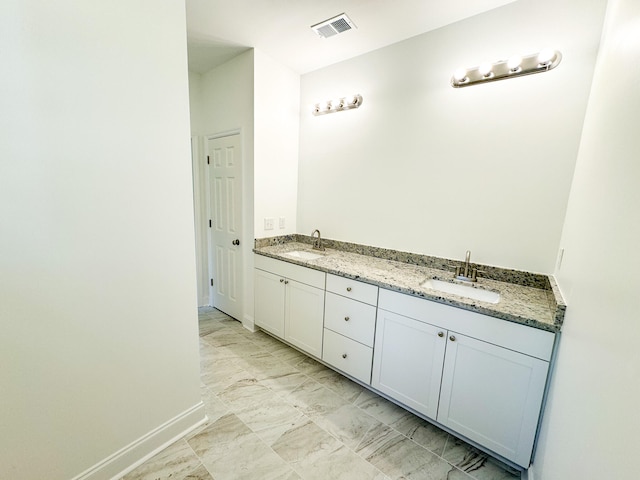 bathroom featuring tile patterned flooring and vanity