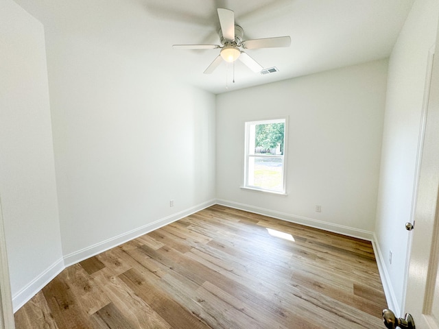 empty room featuring ceiling fan and light hardwood / wood-style flooring