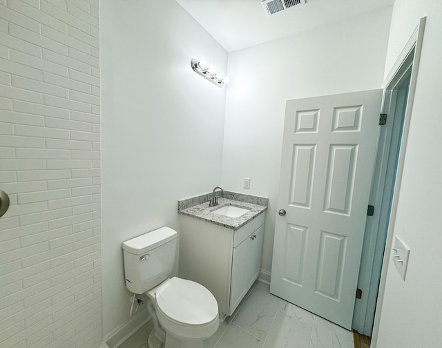 bathroom with tile patterned flooring, toilet, and vanity