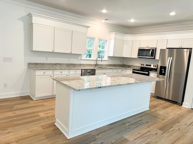 kitchen with light hardwood / wood-style floors, sink, stainless steel appliances, and white cabinets