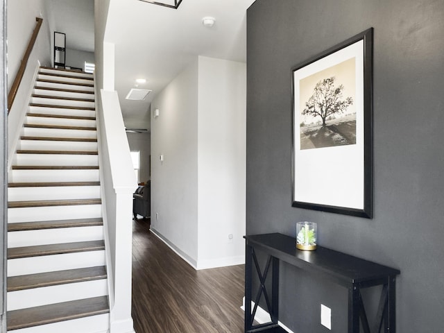 stairway with recessed lighting, baseboards, and wood finished floors