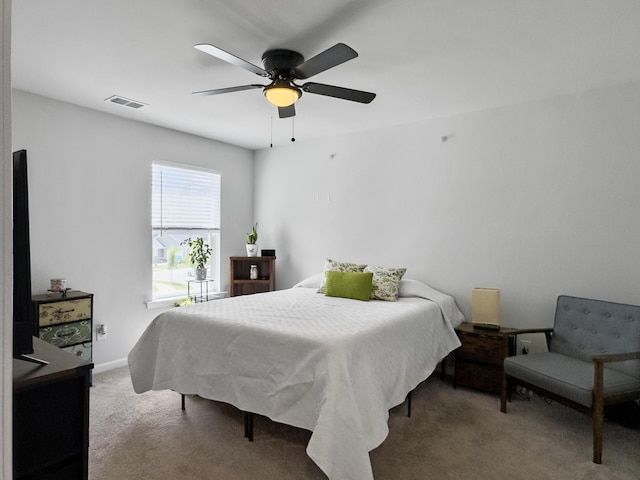 bedroom with visible vents, carpet flooring, baseboards, and a ceiling fan