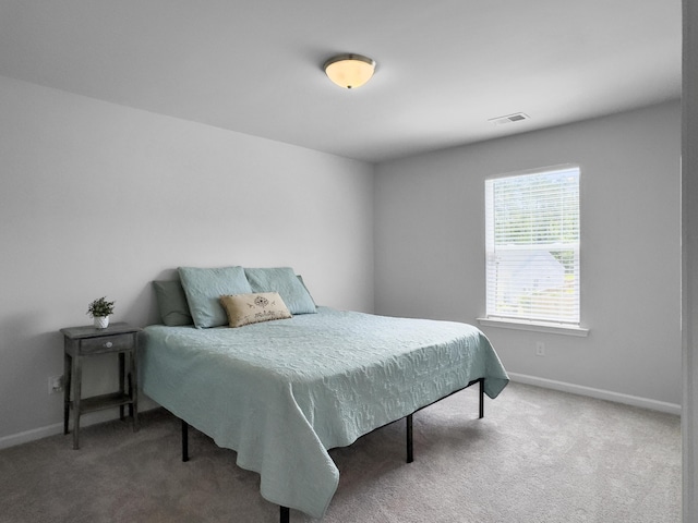 carpeted bedroom featuring baseboards and visible vents