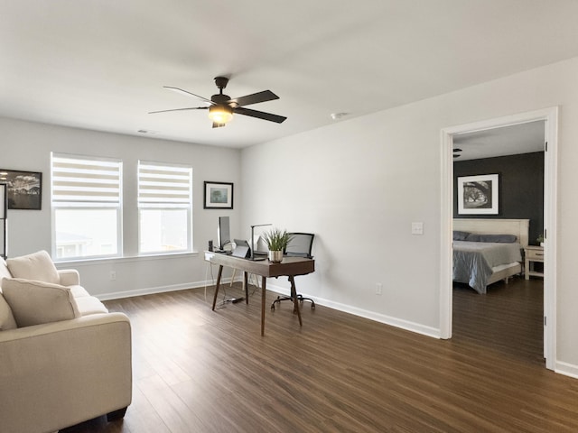 home office with baseboards, dark wood-style flooring, ceiling fan, and visible vents