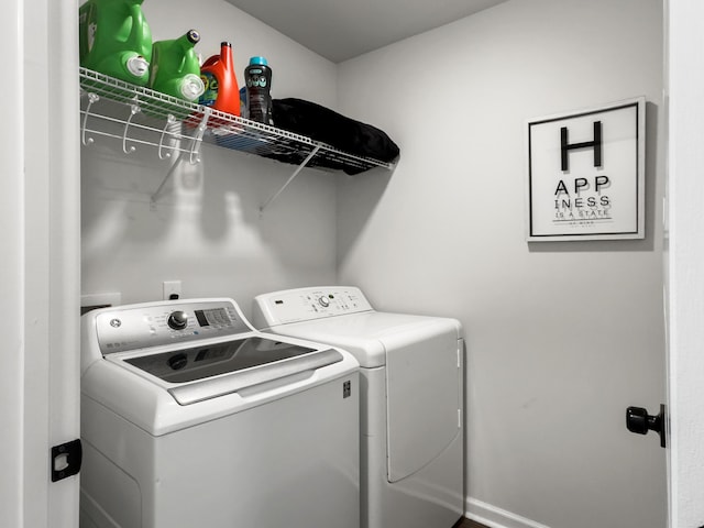 laundry room featuring baseboards, laundry area, and independent washer and dryer