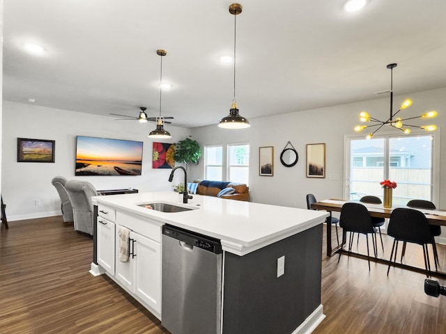kitchen with a notable chandelier, a sink, dishwasher, open floor plan, and dark wood-style floors