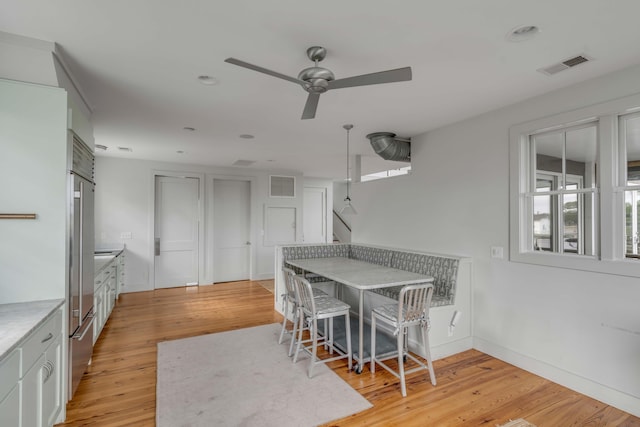 dining area featuring light hardwood / wood-style flooring and ceiling fan