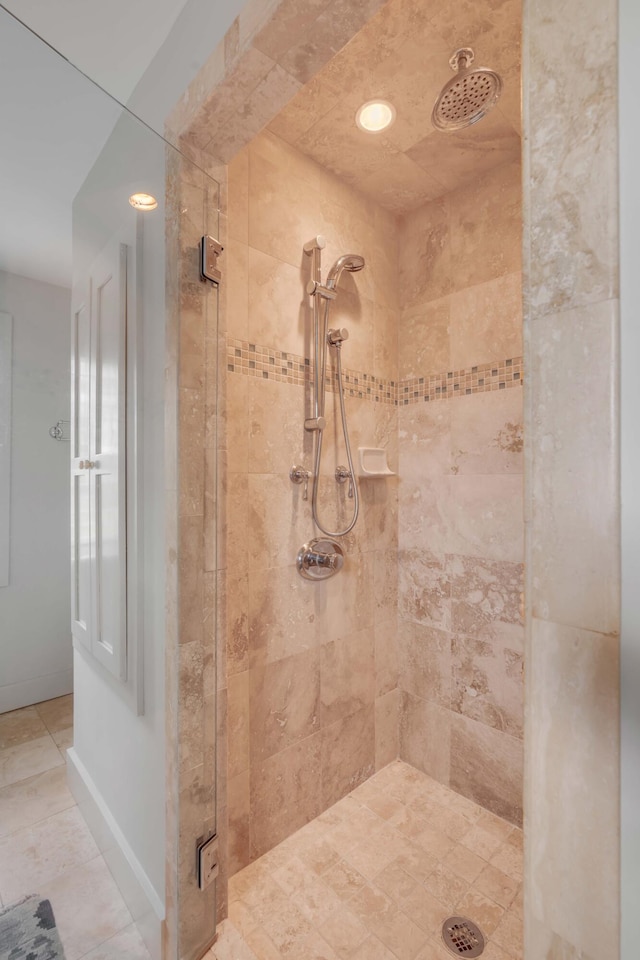 bathroom with a shower with door