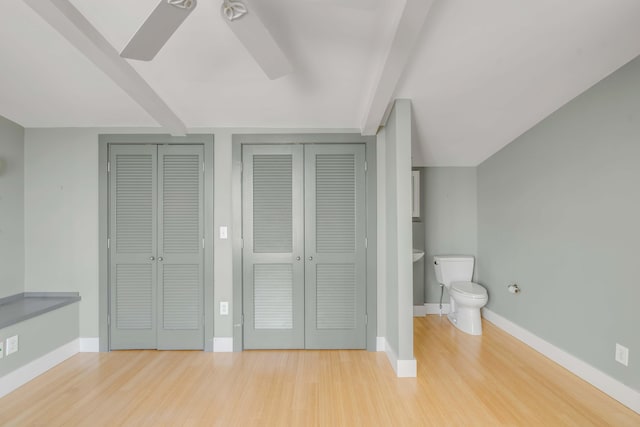 bathroom with hardwood / wood-style flooring, toilet, and ceiling fan