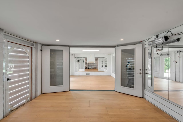 doorway to outside with french doors and light hardwood / wood-style flooring