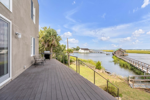 wooden terrace featuring a water view and area for grilling