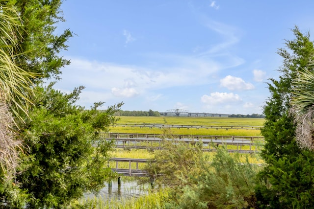 exterior space with a rural view and a water view