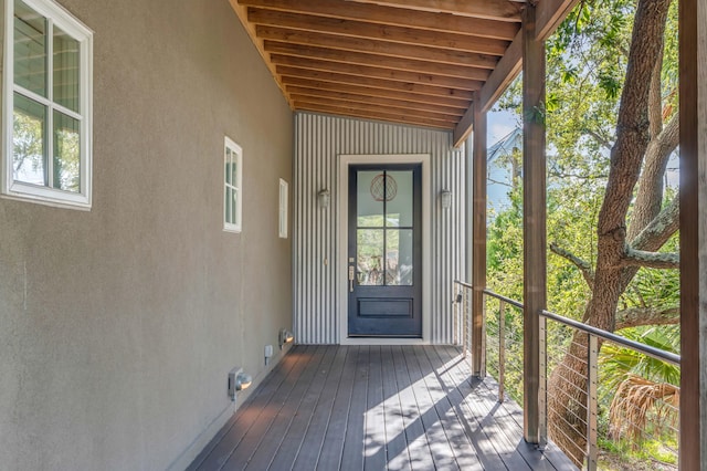 unfurnished sunroom with vaulted ceiling with beams and a healthy amount of sunlight