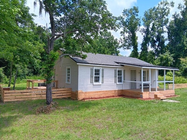 view of front of property with covered porch and a front lawn