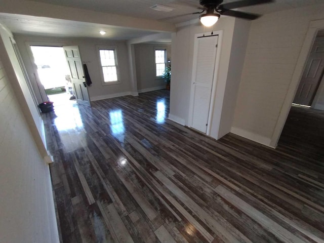 interior space featuring ceiling fan and dark wood-type flooring