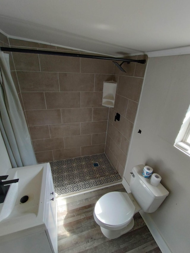 bathroom featuring hardwood / wood-style flooring, toilet, and curtained shower