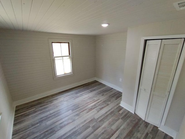 unfurnished bedroom with a closet and wood-type flooring