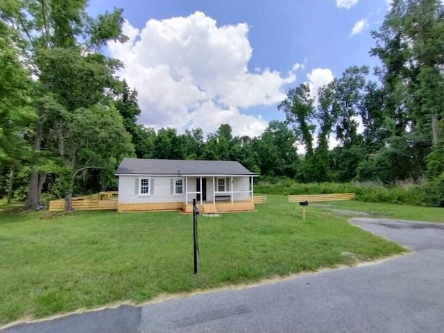 single story home featuring a deck and a front yard