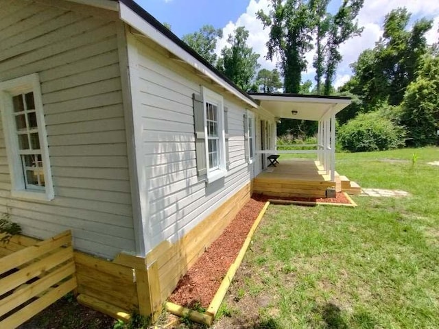 view of side of property with a yard