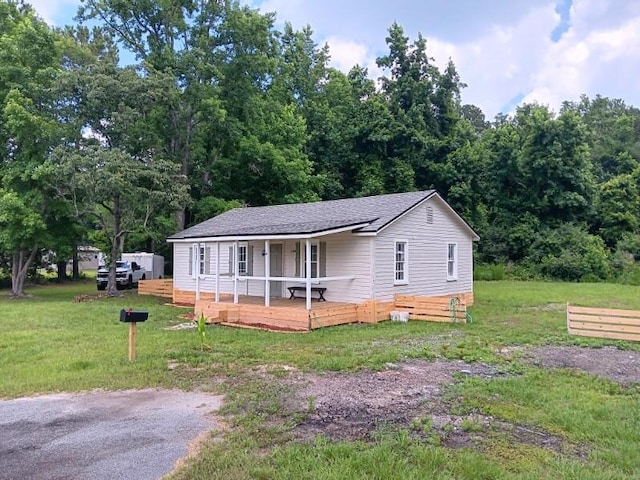 view of front of home with a porch and a front yard