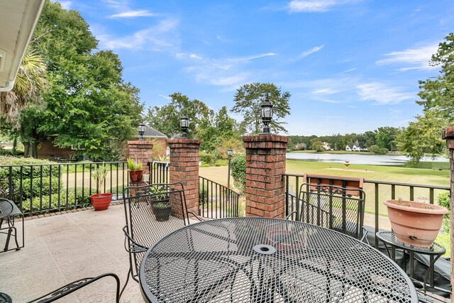 view of patio / terrace featuring a water view and outdoor dining area