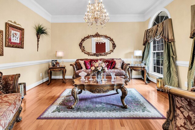 living room featuring plenty of natural light, wood finished floors, ornamental molding, and an inviting chandelier