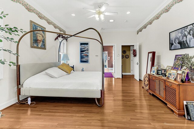 bedroom featuring ceiling fan, crown molding, and hardwood / wood-style floors