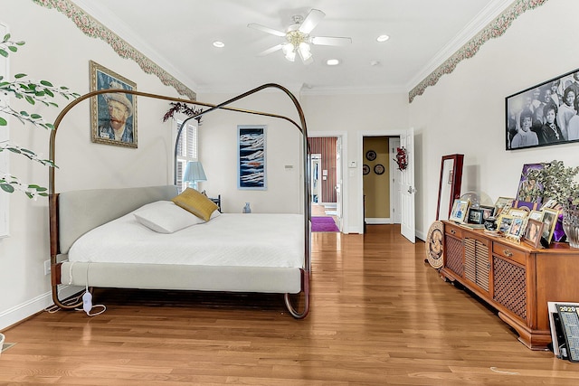 bedroom with baseboards, crown molding, light wood-style floors, and recessed lighting
