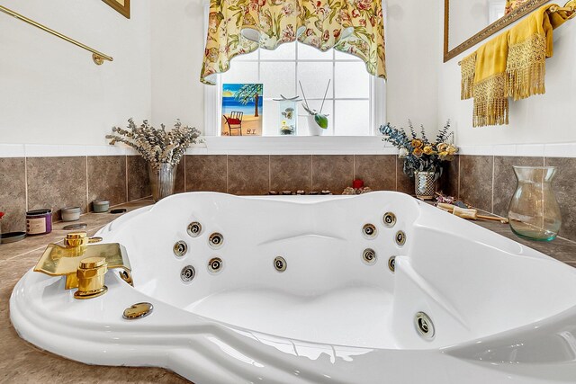 bathroom with a relaxing tiled tub