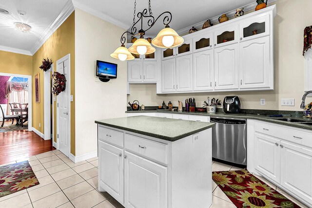 kitchen featuring white cabinets, a kitchen island, dishwasher, crown molding, and a notable chandelier