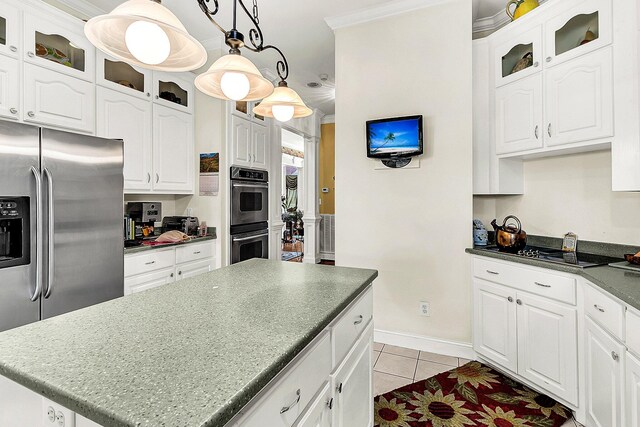 kitchen featuring appliances with stainless steel finishes, white cabinets, light tile patterned floors, pendant lighting, and crown molding