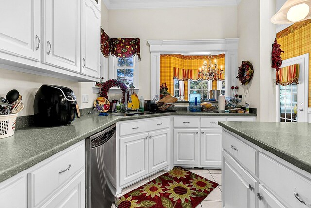 kitchen with light tile patterned floors, a chandelier, white cabinetry, dishwasher, and crown molding