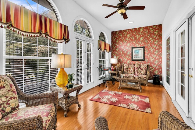 interior space with hardwood / wood-style floors, wallpapered walls, and a ceiling fan