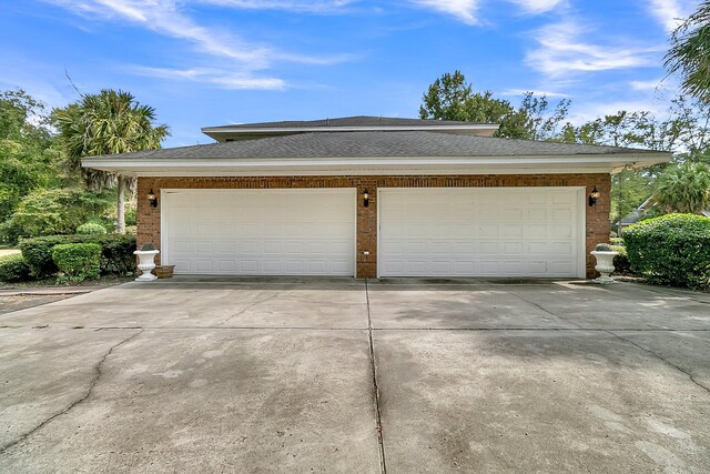 garage featuring concrete driveway
